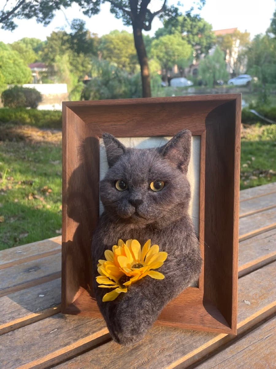 Gray cat with sunflower portrait outdoors